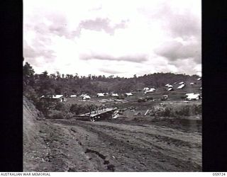 DONADABU, NEW GUINEA. 1943-11-03. CAMP AREA OF THE 24TH AUSTRALIAN FIELD COMPANY, ROYAL AUSTRALIAN ENGINEERS. IN THE CENTRE SAPPERS OF THE UNIT CAN BE SEEN WORKING ON THE CONSTRUCTION OF A NEW ..