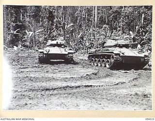 TOROKINA, BOUGAINVILLE, 1945-08-02. A MATILDA TANK BECAME BOGGED DURING THE TRIALS OF THE M24 GENERAL CHAFFEE LIGHT TANKS CONDUCTED FOR THE WAR OFFICE. SHOWN ARE TWO LIGHT TANKS PULLING A MATILDA ..