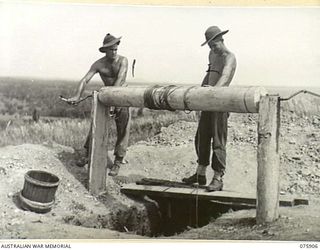 HANSA BAY AREA, NEW GUINEA. 1944-09-05. Q103066 PRIVATE W.T. BAMBERRY (1) AND NX77877 CORPORAL H. JONES (2), NO. 8 PLATOON, A COMPANY, 25TH INFANTRY BATTALION SINKING A WELL FOR WATER NEAR THEIR ..