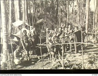 SHAGGY RIDGE, DUMPU VALLEY, NEW GUINEA. 1944-06-018. MEMBERS OF A PATROL FROM 11TH DIVISION CARRIER COMPANY WHO HAVE BEEN ACCOMPANYING MEMBERS OF THE MILITARY HISTORY SECTION ON AN EXPEDITION ..