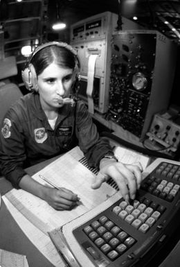 SGT. Debbie Whitacre uses a computer to transcribe, record and pass information that she received from a dropsonde sensor dropped by parachute from a WC-130 Hercules aircraft. The dropsonde is used to monitor a typhoon's direction so that the information can be promptly relayed to the Joint Typhoon Warning Center (JTWC)