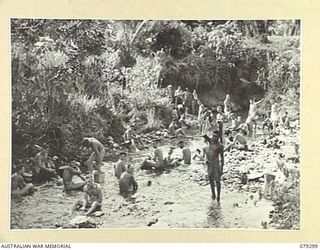 MELKONG RIVER, NEW BRITAIN. 1945-02-20. TROOPS OF THE 2/14TH FIELD REGIMENT, ENJOYING A BATH OR A WASH IN THE SHALLOWS OF THE RIVER NEAR THEIR CAMP