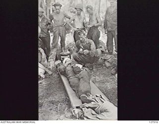 WANIGELA, NEW GUINEA. 1942-10-08. UNITED STATES SERVICEMAN WHO WAS WOUNDED WHEN TWO AMERICAN LUGGERS BRINGING MEN AND SUPPLIES FROM MILNE BAY WERE BOMBED OFF PONGANI BY A UNITED STATES FIFTH AIR ..