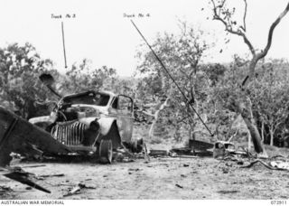 PORT MORESBY AREA, NEW GUINEA. 1943-09-07. TWO OF FIVE TRUCKS CARRYING MEMBERS OF THE 2/33RD INFANTRY BATTALION AND THE 158TH GENERAL TRANSPORT COMPANY WHICH WERE DESTROYED WHEN A LIBERATOR BOMBER ..