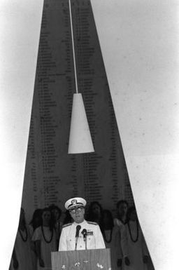 ADM James D. Watkins, commander in chief, U.S. Pacific Fleet, address the guests attending the ceremonies commemorating the 40th anniversary of the Japanese attack on Pearl Harbor. Members of the Kamehameha School Concert Glee Club stand behind Watkins in the shrine room aboard the USS ARIZONA Memorial where the ceremony took place
