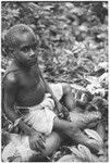 Sacrifice in shrine. Young boy with sacrificial pig