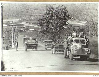 FOUR MILE VALLEY, PAPUA, NEW GUINEA. 1944-01-02. A VIEW OF THE MAIN PORT MORESBY ROAD AT FOUR MILE VALLEY, SHOWING TRAFFIC CONTROL POINT AND NATIVES WAITING FOR A LIFT