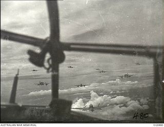 Airborne En Route to Lindenhafen, New Britain. 1944-01-17. View through the nose of a Beaufort Bomber aircraft of No. 100 Squadron RAAF, showing other Beaufort aircraft of Nos. 6, 8 and 100 ..