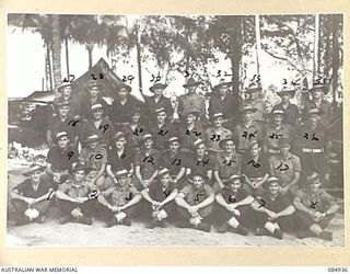 GREEN ISLAND, QLD. 1944-12-21. 109 BRIGADE WORKSHOP NCOS AND MEN BEFORE A SETTING OF COCONUT PALMS IN THE UNIT LINES. (FOR IDENTIFICATION OF 34 NAMED PERSONNEL REFER PROVISIONAL CAPTION)
