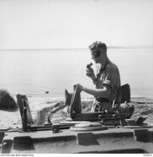 CAPE WOM, WEWAK AREA, NEW GUINEA. 1945-08-30. TROOPER E.M. LAWLER IN TURRET OF A MATILDA TANK AT 2/4 ARMOURED REGIMENT WORKSHOP, CORPS OF AUSTRALIAN ELECTRICAL AND MECHANICAL ENGINEERS