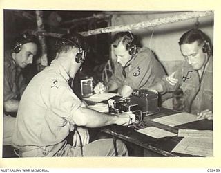 BOUGAINVILLE ISLAND, 1945-01-21. PERSONNEL OF THE 2ND FIELD REGIMENT SIGNALS SECTION OPERATING FULLERPHONES AT THE SIGNALS OFFICE REGIMENTAL HEADQUARTERS. IDENTIFIED PERSONNEL ARE:- VX147175 ..