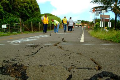 [Earthquake] Kapaau, HI, October 25, 2006 - DOT crews examine a crack that split the pavement at Pololu Lookout after two earthquakes struck the Big Island of Hawaii. Adam DuBrowa/FEMA.