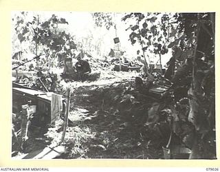 TSIMBA RIDGE, BOUGAINVILLE ISLAND. 1945-02-06. NX161744 LIEUTENANT E.A. TUCKWELL, SECOND- IN- CHARGE, 101ST BRIGADE SUPPORT COMPANY, GIVING THE SIGNAL TO FIRE TO THE MORTAR CREW PREPARING FOR ..