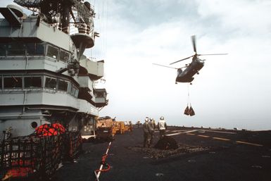 A CH-46 Sea Knight helicopter of Helicopter Combat Support Squadron 6 (HC-6), Detachment 3, delivers supplies to the amphibious assault ship USS GUAM (LPH-9) during vertical replenishment off the coast of Lebanon