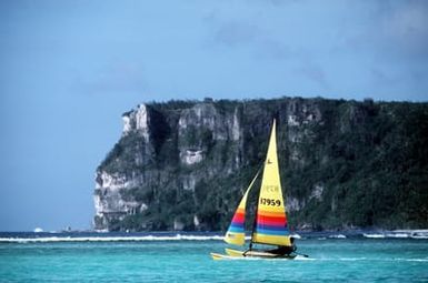 A sailboat makes its way past Two Lovers Point