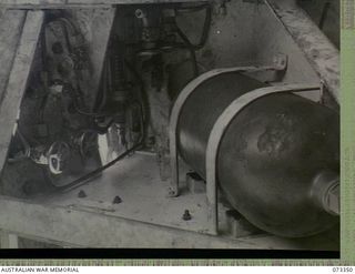 PORT MORESBY, NEW GUINEA. 1944-05-24. AN AIR CHARGING RESERVOIR MOUNTED ON NO 2 GUN AT BASILISK BATTERY, 801ST ANTI AIRCRAFT AND COAST ARTILLERY BATTERY AT HQ MORESBY BASE SUB AREA