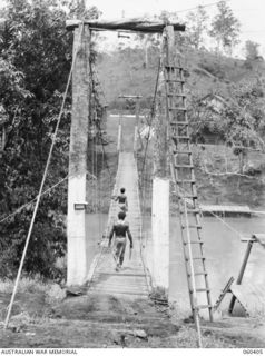 SOGERI, NEW GUINEA. 1943-11-20. WIRE SUSPENSION BRIDGE OVER THE LALOKI RIVER BUILT BY THE STAFF MEMBERS OF THE SCHOOL OF SIGNALS, NEW GUINEA FORCE