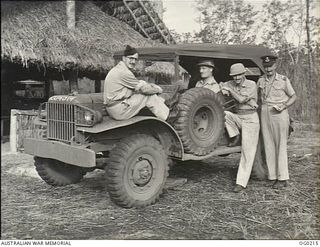 VIVIGANI, GOODENOUGH ISLAND, PAPUA. C. 1943-11. MEMBERS OF A RAAF PUBLIC RELATIONS PARTY WITH THEIR VEHICLE. LEFT TO RIGHT: PILOT OFFICER S. HUTCHINSON; FLIGHT LIEUTENANT (FLT LT) J. WATERS; ..