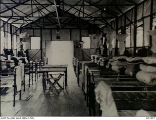 Port Moresby, Papua. 1940-02. Interior of a new RAAF hut at Ronedolu Camp, these barracks showing mosquito netting above each bed, and bedding neatly folded