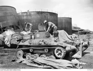 NAURU ISLAND. 1945-09-16. TROOPS OF THE 31/51ST INFANTRY BATTALION EXAMINING JAPANESE TYPE 97 TANKETTES CAPTURED SOON AFTER MEMBERS OF THE UNIT OCCUPIED THE ISLAND