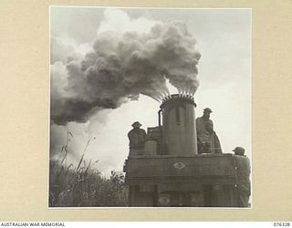 LAE, NEW GUINEA. 1944-09-27. PERSONNEL OF UNITED STATES ARMY CHEMICAL WARFARE UNIT TESTING A PORTABLE SMOKE SCREEN TRUCK IN CO OPERATION WITH THE 43RD FIELD ORDNANCE DEPOT