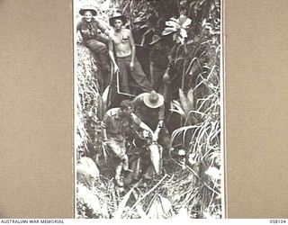 FINSCHHAFEN, NEW GUINEA, 1943-10-02. A JAPANESE MOTORCYCLE, COMPLETE WITH TRAILER WAS TAKEN AMONG THE BOOTY IN THE VICINITY OF LANGEMAK BAY. MEMBERS OF THE 2/15TH AUSTRALIAN INFANTRY BATTALION, 9TH ..