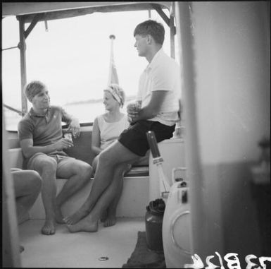 Two men and a woman drinking on a sailing boat, Fiji, 1966 / Michael Terry