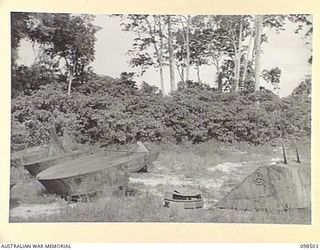 PANIPAI AIRSTRIP, NEW IRELAND. 1945-10-26. JAPANESE AMPHIBIOUS TANK ATTACHMENTS ON THE AIRSTRIP. THEY ARE (LEFT TO RIGHT) BOW ATTACHMENT; SPECIAL TURRET; AND STERN ATTACHMENT WITH TWIN RUDDERS. THE ..
