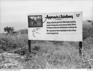 FINSCHHAFEN AREA, NEW GUINEA, 1944-03-17. ONE OF MANY BATTLE SIGNS IN THE FINSCHHAFEN AREA, THIS SIGN AT THE APPROACH TO SATTELBERG IS 200 YARDS ABOVE THE POINT WHERE "B" COMPANY, 2/48TH INFANTRY ..