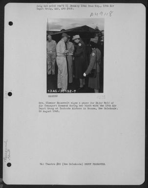 Mrs. Eleanor Roosevelt Signs A Paper For Major Wolf Of Air Transport Command During Her Visit With The 13Th Air Depot Group At Tontouta Airbase In Noumea, New Caledonia. 25 August 1943. (U.S. Air Force Number 3A49118)