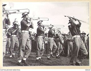 HERBERTON RACECOURSE, WONDECLA, ATHERTON TABLELAND, QLD. 1945-01-19. THE 2/13 INFANTRY BATTALION BAND COMPETING IN THE BAND CONTEST DURING THE 9 DIVISION GYMKHANA. IDENTIFIED PERSONNEL ARE:- ..