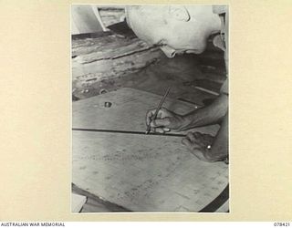 BOUGAINVILLE ISLAND. 1945-01-20. VX87706 BOMBARDIER J. BELL, 2ND FIELD REGIMENT, TARGET PLOTTING IN THE NO. 5 BATTERY COMMAND POST