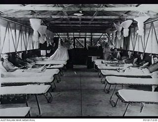 Goodenough Island, D'Entrecasteaux Islands, Papua, 1944-04-01. Interior of the officers' ward of No. 5 Medical Receiving Station at the Headquarters of No. 71 Wing RAAF. Several of the ward's camp ..