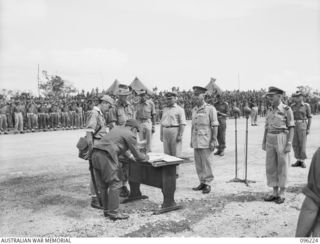 CAPE WOM, NEW GUINEA, 1945-09-13. LIEUTENANT-GENERAL ADACHI, COMMANDER 18 JAPANESE ARMY IN NEW GUINEA, SIGNING THE INSTRUMENT OF SURRENDER. HE ACCEPTED THE TERMS UNCONDITIONALLY. LIEUTENANT-GENERAL ..