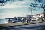A view of the Papeete waterfront with passenger boat tied up at the dock and administration buildings in background