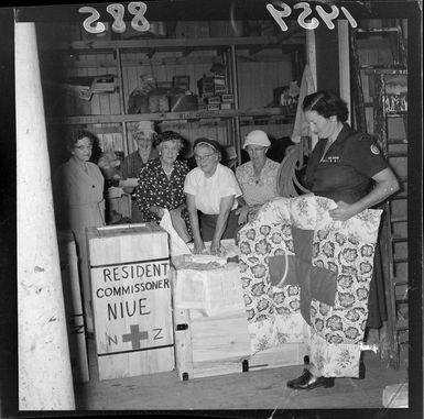 Red Cross helpers packing cases for Niue Island