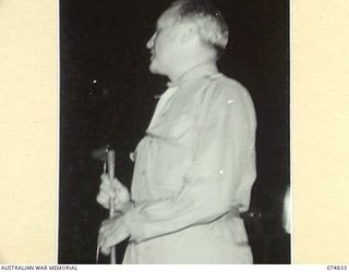 LAE, NEW GUINEA. 1944-07-24. JACK BENNY, AMERICAN ENTERTAINER AT THE MICROPHONE DURING A CONCERT STAGED BY THE JACK BENNY SHOW DURING THE UNIT'S TOUR OF THE NEW GUINEA FORWARD AREAS