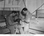 University of Washington Bikini Scientific Resurvey Group members assembling nets, probably on board the USS CHILTON, summer 1947