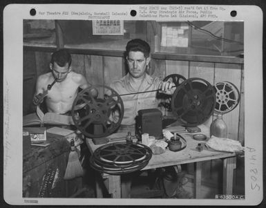 A Gi Rewinds A Roll Of Movie Film. Kajalein, Marshall Islands. 23 April 1944. (U.S. Air Force Number B63500AC)
