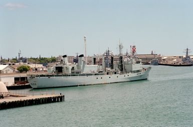 Starboard quarter view of the Canadian replenishment ship HMCS PROTECTEUR (AOR 509) tied up at the Naval Supply Depot, Berth Kilo no. 8, at Kuaha island. The ship is taking part in Operation RIMPAC 2000