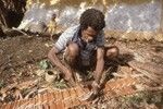 Kainding Biank making roof thatch 2 of 2