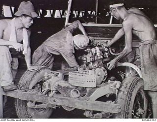 Motor repairs being carried out by Japanese mechanics at a base. Japanese prisoners of war (POWs) worked under the supervision of RAN personnel. Work on an RAN base commenced in August 1948. It was ..