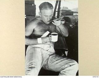 NAGADA, NEW GUINEA. 1944-09-21. Q28792 PRIVATE P. CLOHERTY, 61ST INFANTRY BATTALION (1), ENJOYS A CUP OF SOUP SUPPLIED BY THE AUSTRALIAN RED CROSS SOCIETY REPRESENTATIVE AT THE 11TH FIELD AMBULANCE