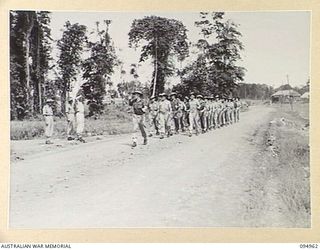 LAE AREA, NEW GUINEA. 1945-08-13. COLONEL I.J. WOOD, COMMANDING OFFICER, 2/7 GENERAL HOSPITAL, TAKING THE SALUTE FROM HOSPITAL STAFF DURING THE MARCH PAST