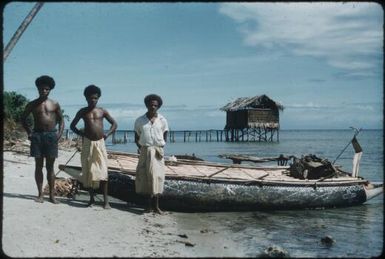 Canoes on Mapamoiwa beach, haus pek pek, (latrine) in background : Mapamoiwa Station, D'Entrecasteaux Islands, Papua New Guinea, 1956-1959 / Terence and Margaret Spencer