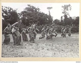 TOROKINA, BOUGAINVILLE, 1945-07-15. THE SACK RACE IN PROGRESS DURING THE COMBINED ALLIED SPORTS CHAMPIONSHIP MEETING AT GLOUCESTER OVAL ARRANGED BY AUSTRALIAN ARMY AMENITIES SERVICE, ATTACHED 4 ..