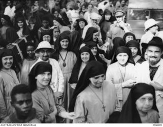 Ramale Mission, Kokopo Area, New Britain. A group of happy nuns at the farewell scene as twenty of a group of 300 white former internees leave Ramale Mission for evacuation to Rabaul to receive ..