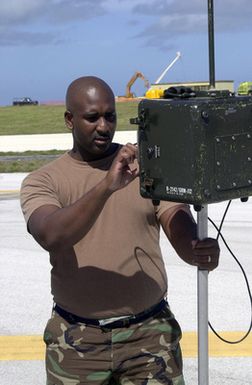 US Air Force (USAF) STAFF Sergeant (SSGT) Carl Campbell, 36th Communication Squadron (CS), reads a portable Instrument Landing System (ILS) receiver on the flight line at Andersen Air Force Base (AFB), Guam. The receiver reads radiation coming out of the antennae that helps aircraft on approach to the runway