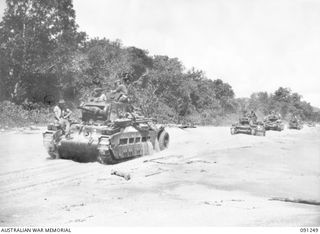 Matilda tanks of  C Squadron, 2/4 Armoured Regiment, rumble along the beach at Kofi village, in New Guinea, on route for Karawop plantation where they will continue their role of support for the ..