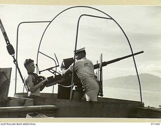 MILNE BAY, NEW GUINEA, 1944-03-15. ABLE SEAMAN S.C. INWOOD (1), WITH ABLE SEAMAN E.J. GILLARD (2), MANNING A 20 MM ANTI-AIRCRAFT GUN ABOARD HT TAROONA